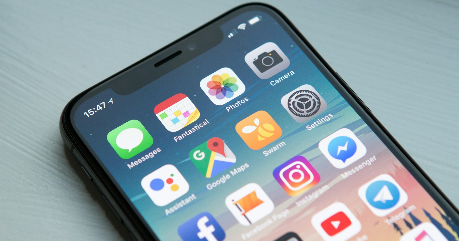Developer checking an iPhone while validating iOS 27 Siri AI and App Intents