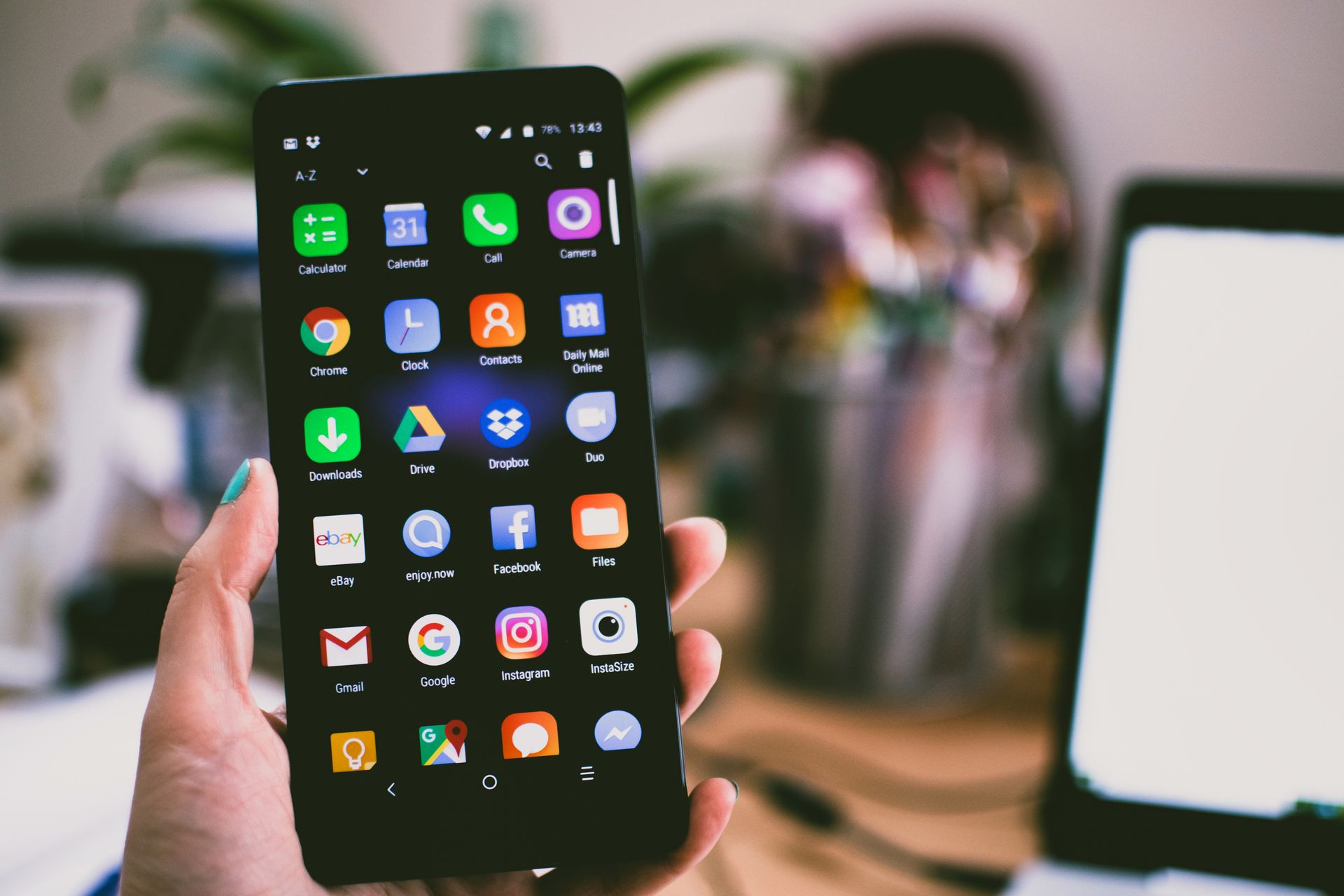 Two hands holding a phone, used to compare the outer display, inner display, orientation, and Split View to test before iPhone Duo ships